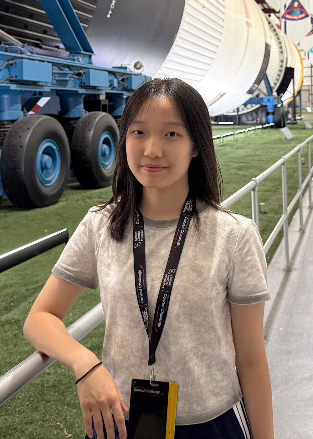 Young woman standing in front of machinery at a science exhibition