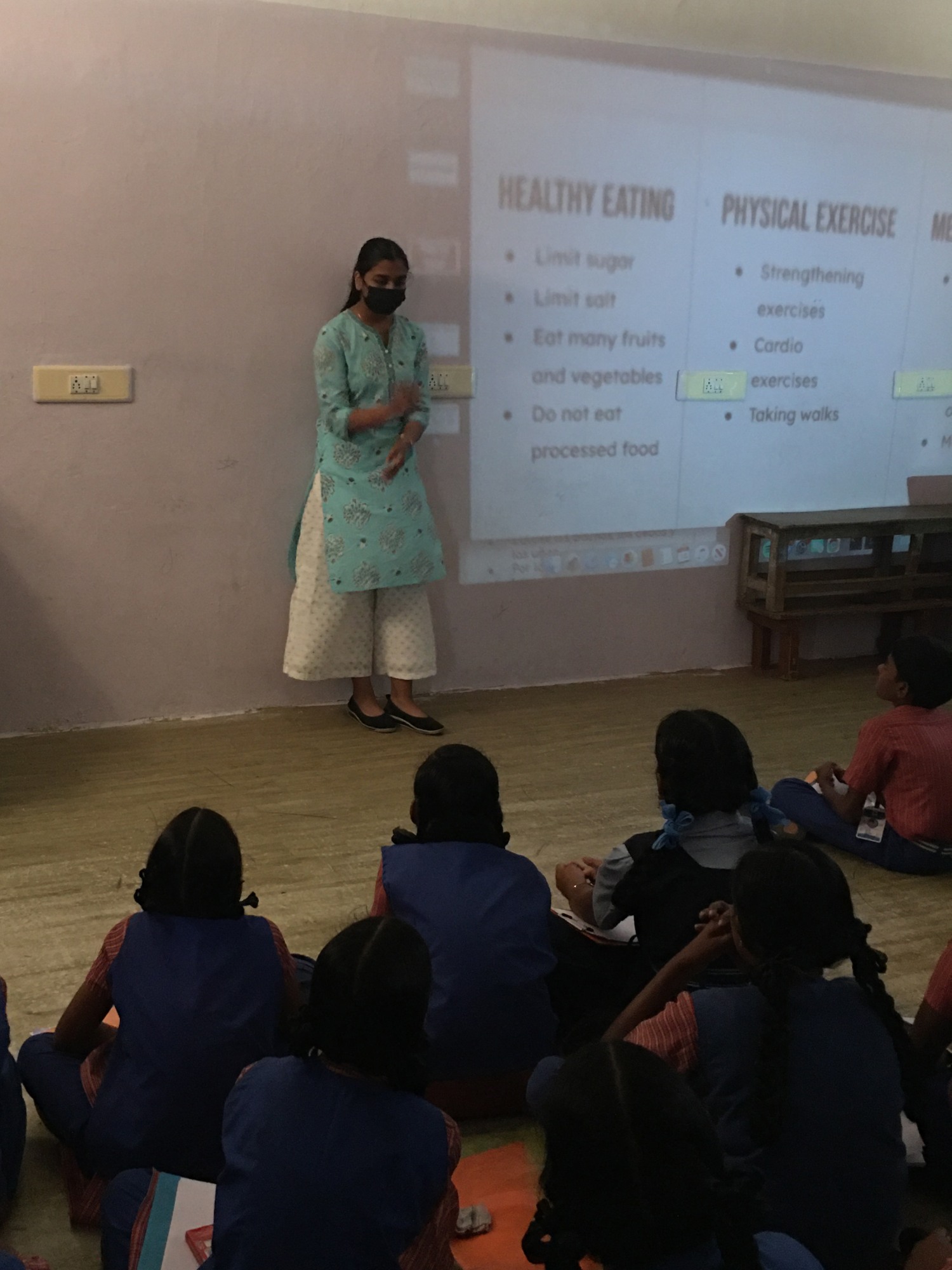 Durga giving a presentation to a group of students