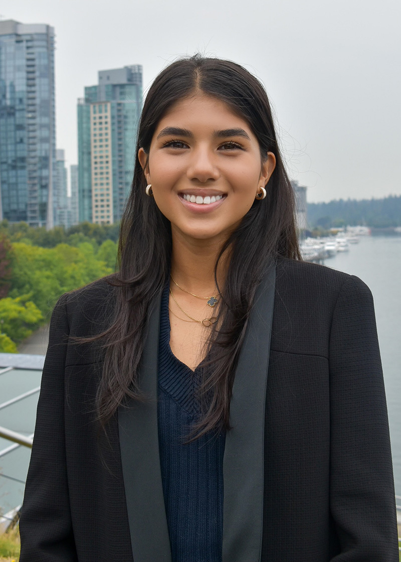 Yasmin smiling in front of a city skyline