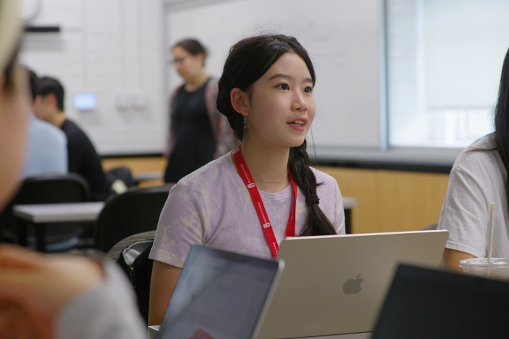 student speaking in a group discussion in class