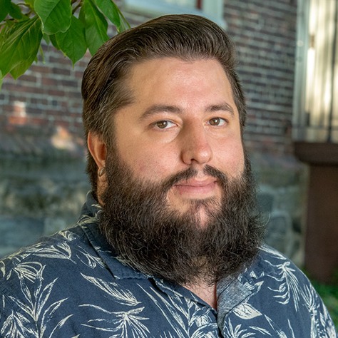 Headshot of Ethan Hebert standing outside