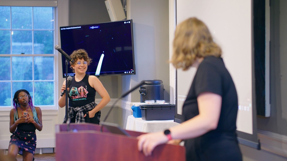 A staff member facilitating a karaoke event.
