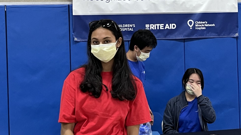 Photo of Riya wearing a face mask and red t shirt