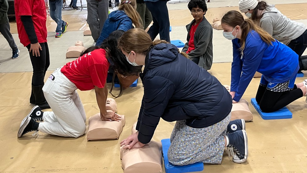 Students learning self defense on a dummy