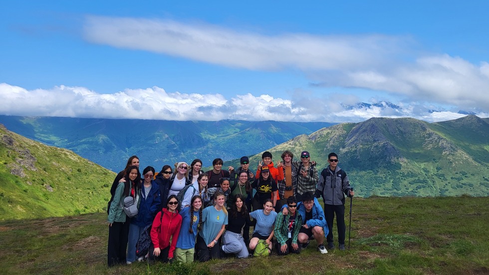 BELL Alaska students standing in front of a mountain range