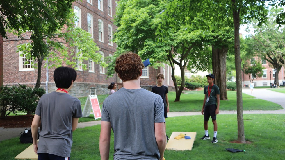 students playing cornhole on the Brown University main green