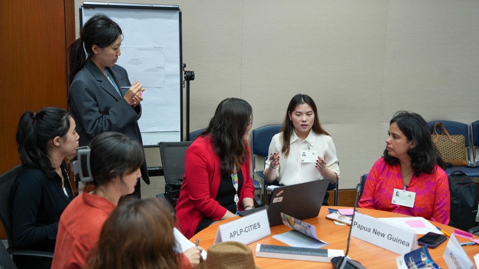 Gracelyn Atmadja speaks at a table of policymakers at the UN