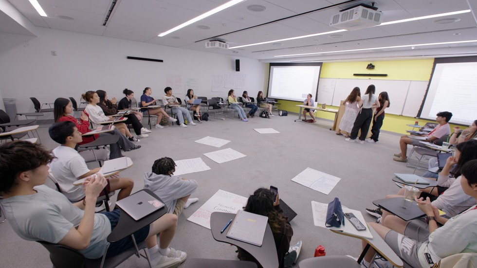 students sitting in a circle working on a group project