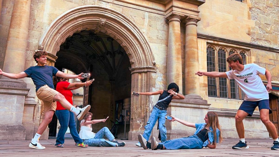 students posing in front of a historical building in Oxford