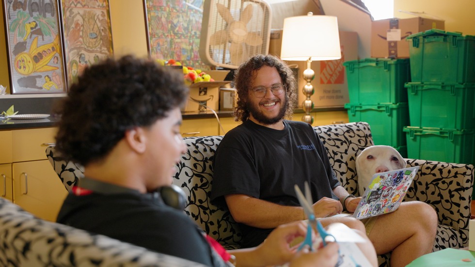 two people working on a craft project and laughing