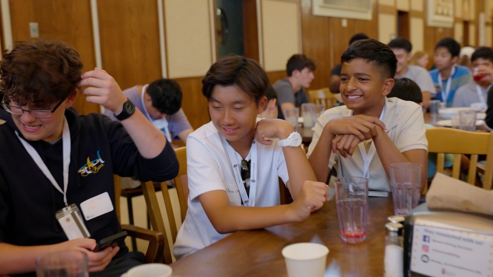 Students socializing at a table in the dining hall