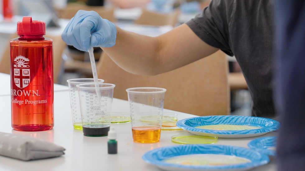 student working on a science experiment in class