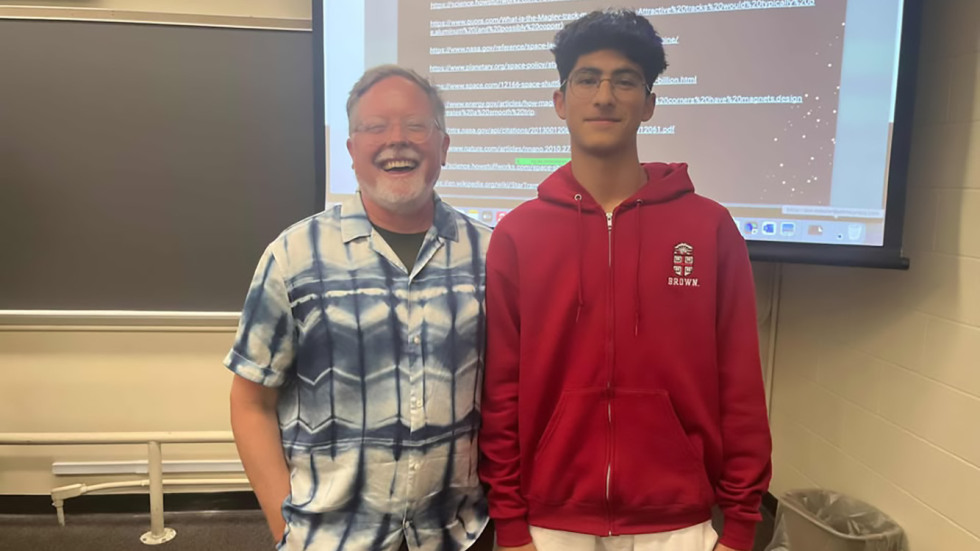 Yusuf standing next to Professor Webster