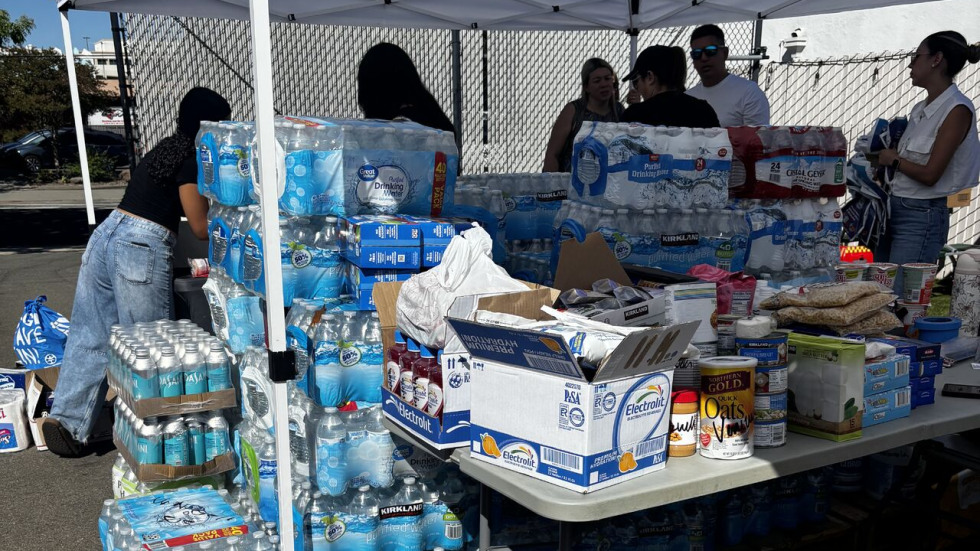 Tables under a tent full of donation supplies
